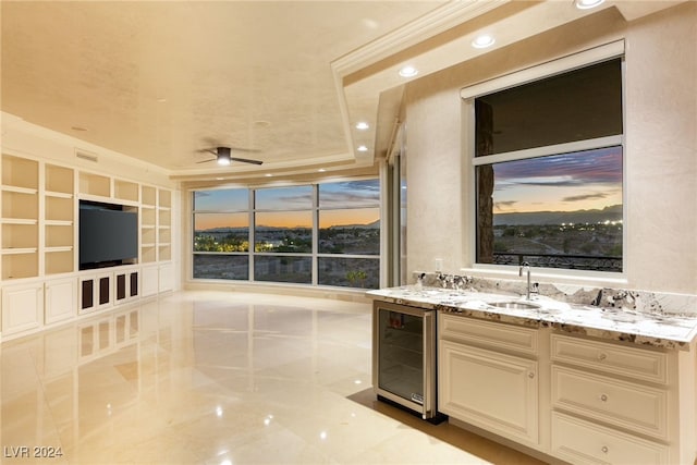 bathroom with wine cooler, vanity, a raised ceiling, and crown molding