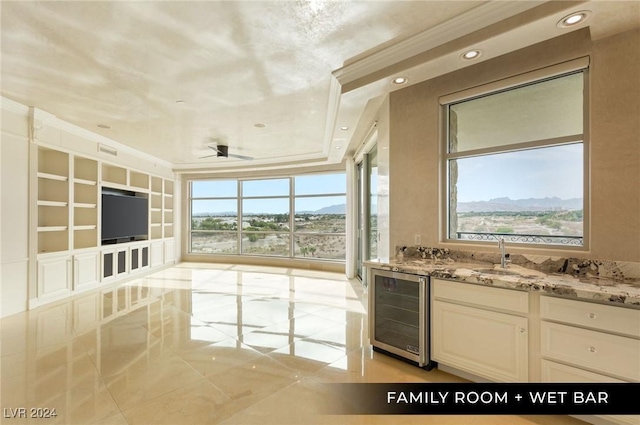 9103 Alta Dr Unit 401, Las Vegas, NV 89145 - interior space with wine cooler, light stone countertops, a sink, white cabinetry, and crown molding