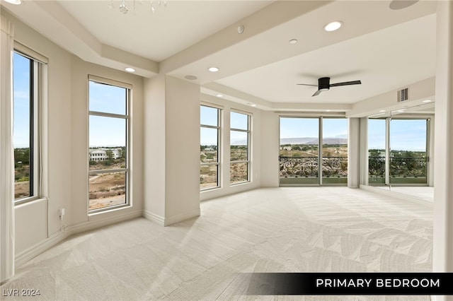 unfurnished sunroom with ceiling fan