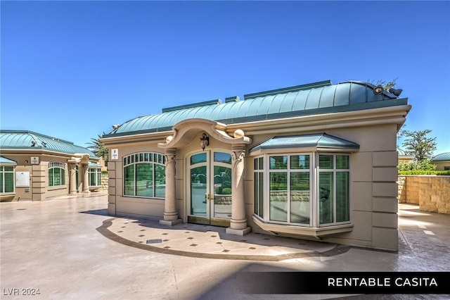 9103 Alta Dr Unit 401, Las Vegas, NV 89145 - property entrance featuring a standing seam roof, metal roof, and french doors