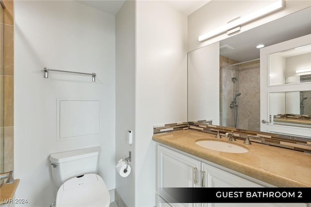 9103 Alta Dr Unit 401, Las Vegas, NV 89145 - full bathroom featuring toilet, a tile shower, and vanity