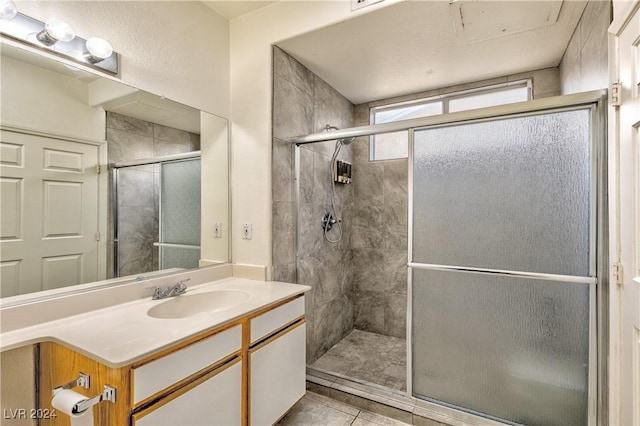 bathroom featuring a stall shower, tile patterned flooring, and vanity