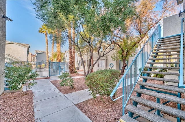 view of home's community with stairs, a residential view, and fence