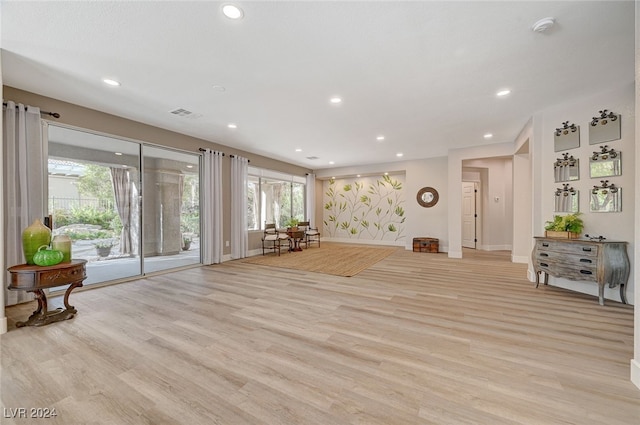 interior space featuring light wood-type flooring and a wealth of natural light