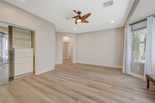 unfurnished bedroom with light hardwood / wood-style floors, ceiling fan, and a closet