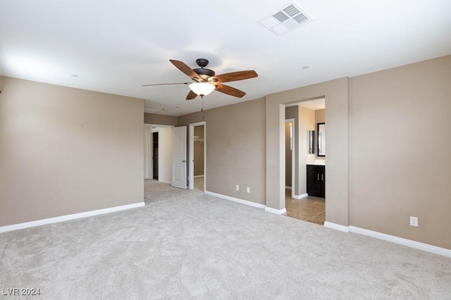 carpeted spare room featuring ceiling fan