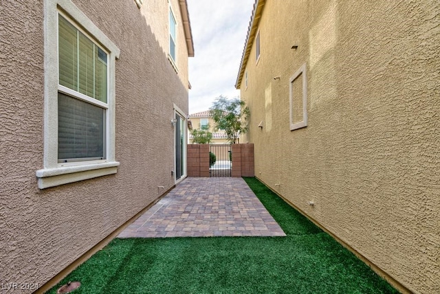 view of side of home with a patio