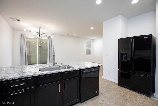 kitchen featuring black appliances, sink, and light stone countertops