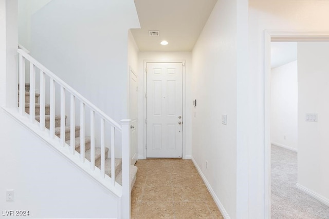 interior space featuring light carpet