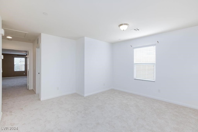 carpeted spare room with a healthy amount of sunlight