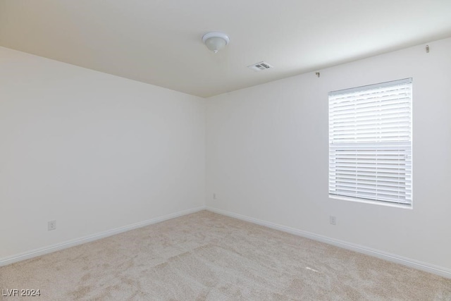 spare room with light colored carpet