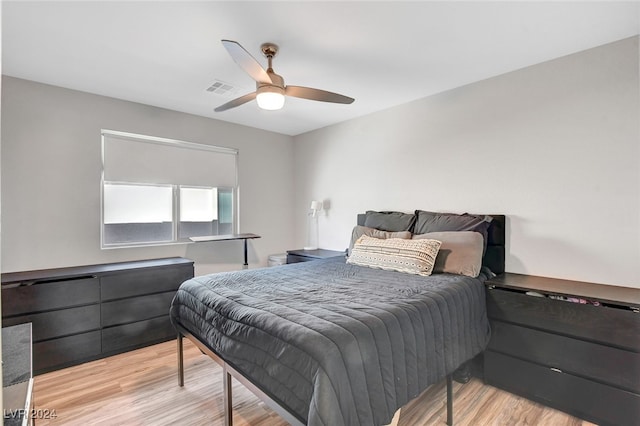 bedroom with light hardwood / wood-style floors and ceiling fan