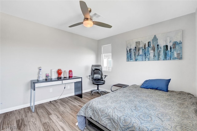 bedroom with light hardwood / wood-style flooring and ceiling fan