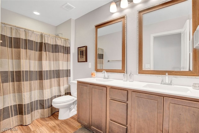 bathroom featuring toilet, vanity, wood-type flooring, and a shower with shower curtain