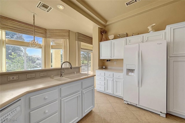 kitchen with white cabinetry, sink, pendant lighting, and white refrigerator with ice dispenser