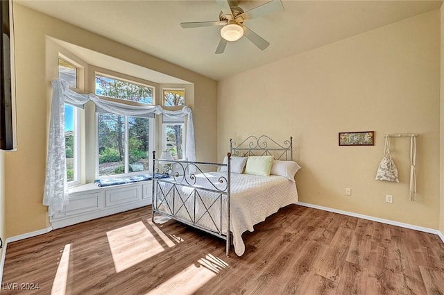 bedroom featuring hardwood / wood-style flooring and ceiling fan