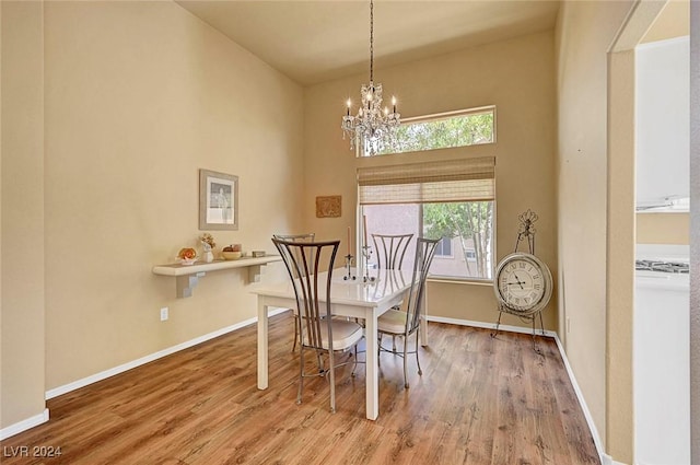 dining space with an inviting chandelier and hardwood / wood-style flooring