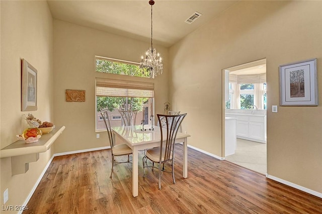 dining room featuring an inviting chandelier and light hardwood / wood-style flooring