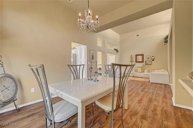 dining room featuring light hardwood / wood-style flooring and a notable chandelier