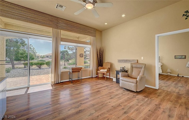 sitting room with ceiling fan, plenty of natural light, and hardwood / wood-style flooring