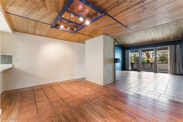 spare room with lofted ceiling, hardwood / wood-style flooring, and wooden ceiling