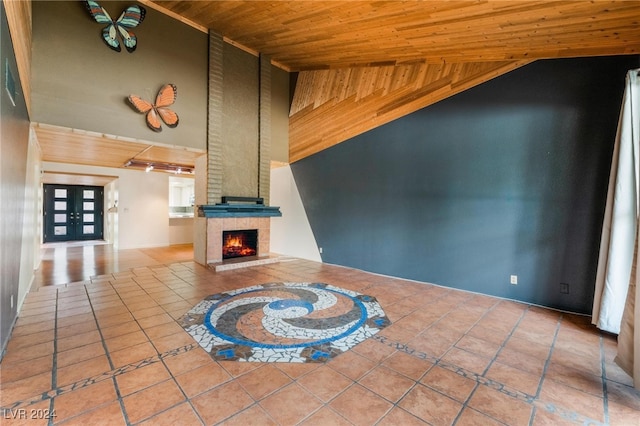 unfurnished living room featuring a fireplace, wood ceiling, tile patterned floors, and lofted ceiling