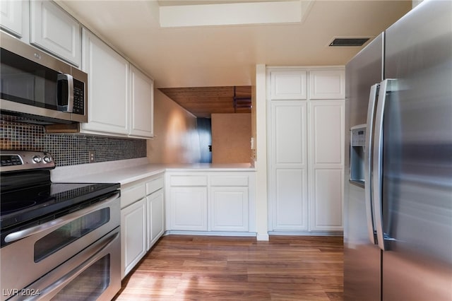 kitchen featuring white cabinetry, appliances with stainless steel finishes, backsplash, and light hardwood / wood-style floors