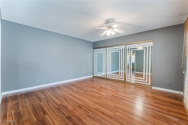 interior space with wood-type flooring, ceiling fan, and a textured ceiling