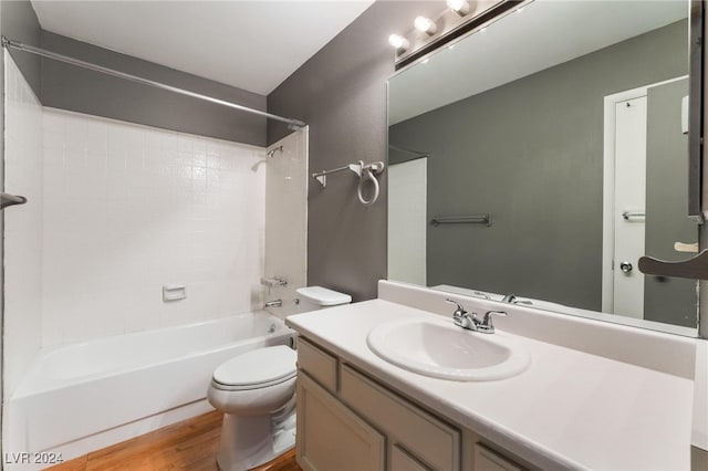 full bathroom with toilet, vanity, hardwood / wood-style floors, and shower / washtub combination