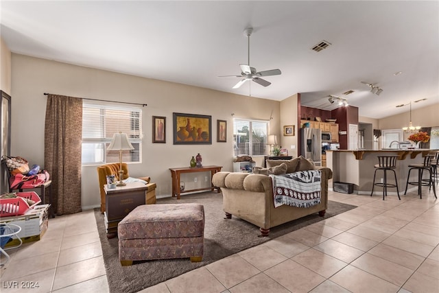 living room with light tile patterned flooring, ceiling fan, and vaulted ceiling