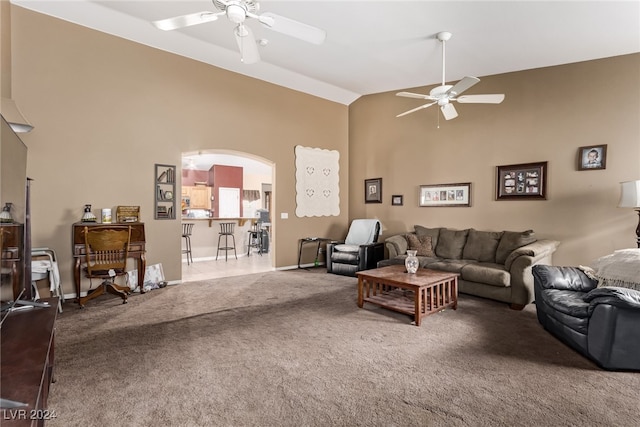 carpeted living room featuring high vaulted ceiling and ceiling fan