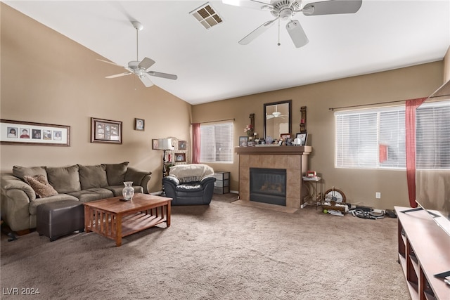 living room with high vaulted ceiling, a tile fireplace, carpet flooring, and ceiling fan