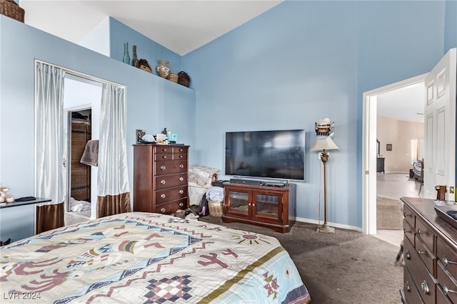 carpeted bedroom featuring a high ceiling