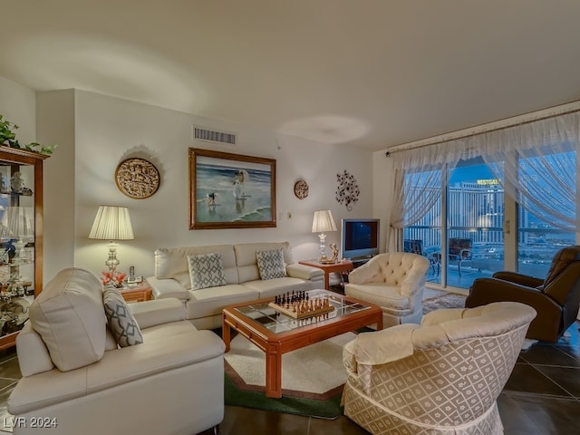 living room with dark tile patterned floors