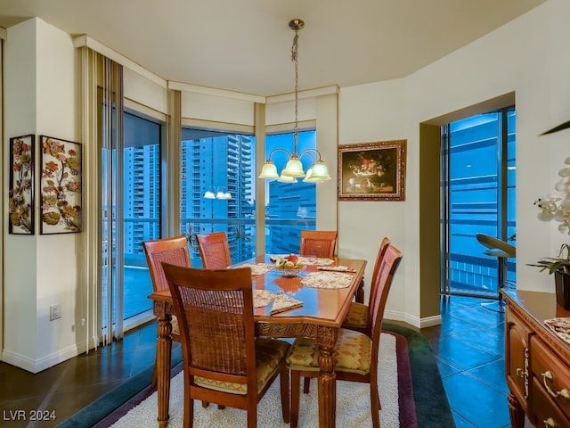 tiled dining space featuring a notable chandelier