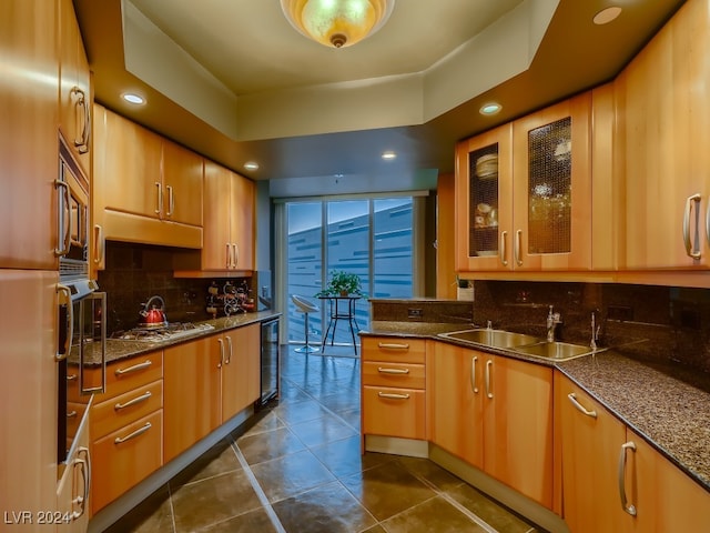 kitchen with wine cooler, dark stone counters, stainless steel gas cooktop, and decorative backsplash