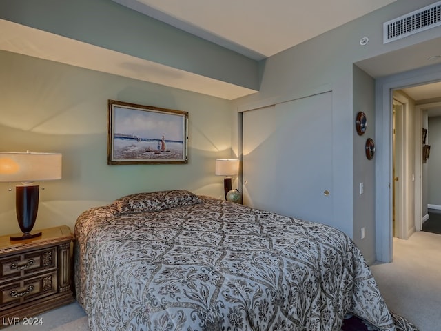 bedroom featuring a closet and light colored carpet