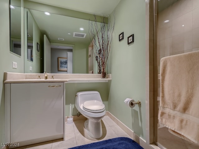 bathroom featuring toilet, vanity, tile patterned floors, and a shower with shower door