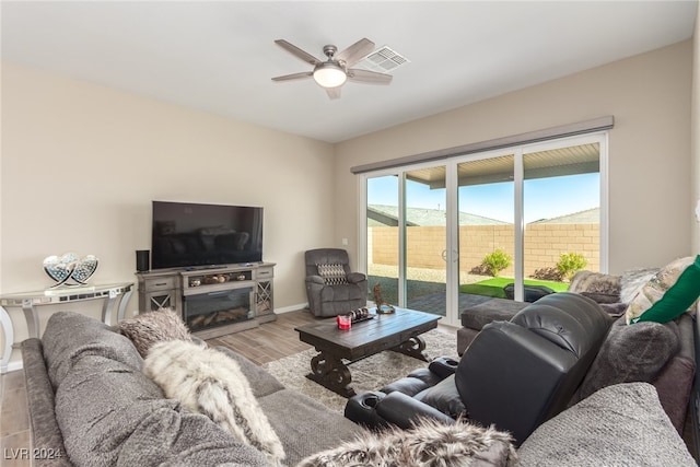 living room with ceiling fan and light wood-type flooring