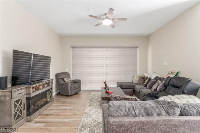 10254 Baronia St, Las Vegas, NV 89141 - living area featuring light wood-style floors, a ceiling fan, and baseboards