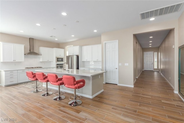 10254 Baronia St, Las Vegas, NV 89141 - kitchen featuring wall chimney exhaust hood, appliances with stainless steel finishes, light countertops, baseboards, and white cabinets