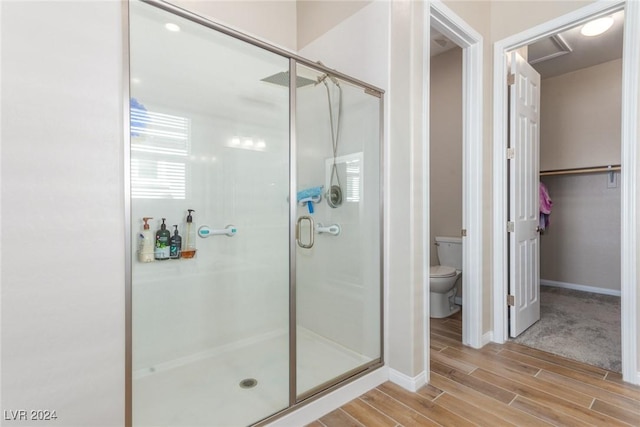 10254 Baronia St, Las Vegas, NV 89141 - full bath featuring toilet, a shower stall, wood finished floors, and baseboards
