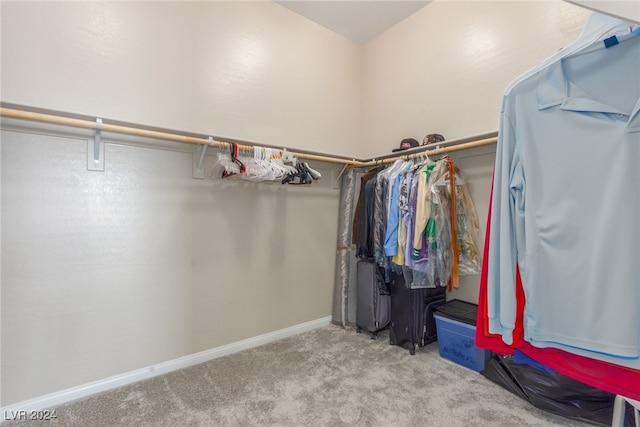 walk in closet featuring light carpet