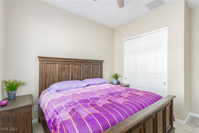 carpeted bedroom featuring ceiling fan and a closet