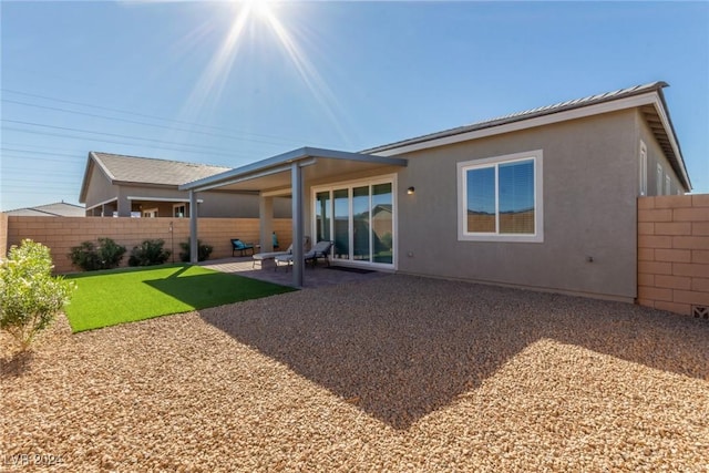 10254 Baronia St, Las Vegas, NV 89141 - rear view of property featuring fence, a patio, and stucco siding
