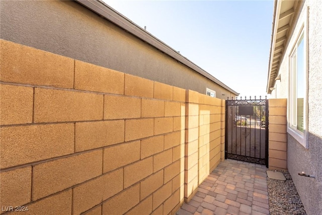 10254 Baronia St, Las Vegas, NV 89141 - view of side of property featuring a gate, stucco siding, and fence