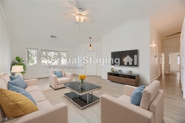 living room with ornamental molding, vaulted ceiling, ceiling fan, and light hardwood / wood-style flooring