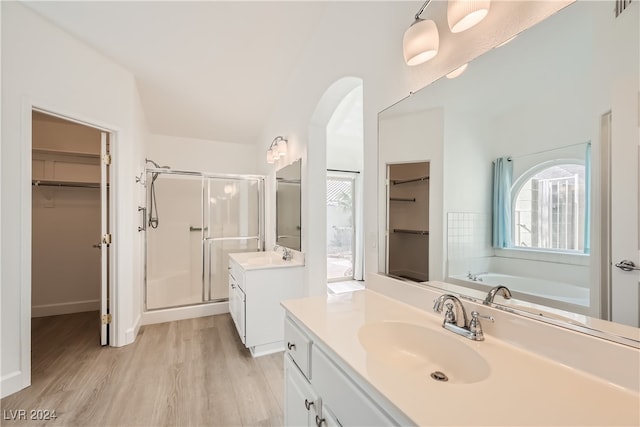 bathroom with vanity, hardwood / wood-style flooring, and separate shower and tub