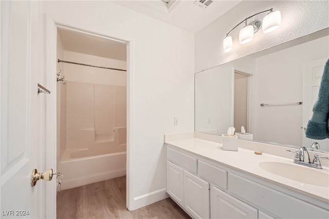 bathroom with shower / bathing tub combination, vanity, and hardwood / wood-style flooring