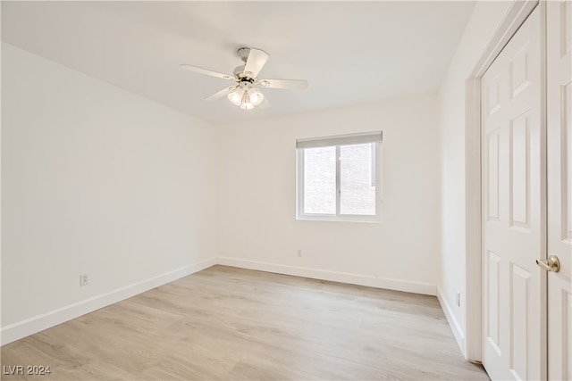 unfurnished bedroom featuring a closet, light wood-type flooring, and ceiling fan